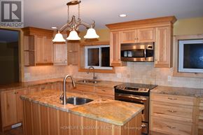 Uxbridge apartment for rent - A kitchen with wooden cabinets and granite countertops.