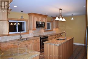 Uxbridge apartment for rent - A kitchen with wooden cabinets and granite countertops.