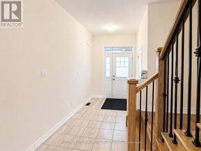Innisfil (Alcona) townhouse for rent - A hallway with a wooden staircase and a white door.