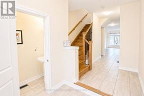 Innisfil (Alcona) townhouse for rent - A hallway with a staircase and a toilet visible.