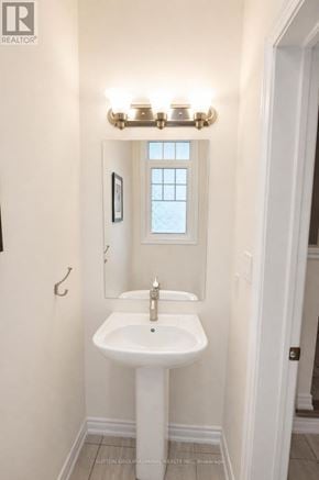 Innisfil (Alcona) townhouse for rent - A white sink in a bathroom with a window above it.