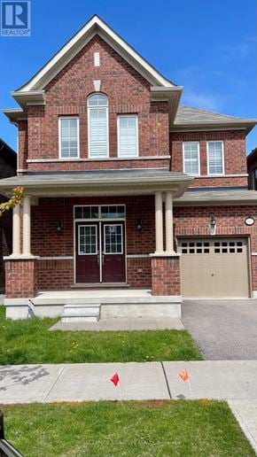 Oakville (Go Glenorchy) apartment for rent - A red brick house with a white garage door.