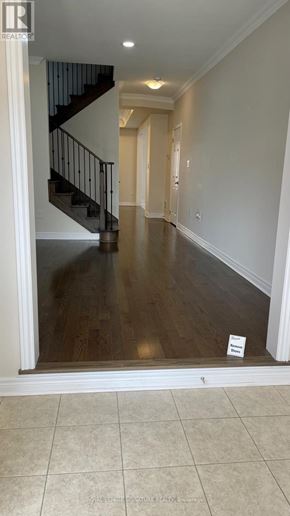 Oakville (Go Glenorchy) apartment for rent - A hallway with a staircase and a sign on the floor.