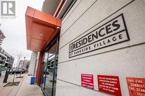 Mississauga (City Centre) condo for rent - The front of a building with a sign that says Residences at Parkside Village.
