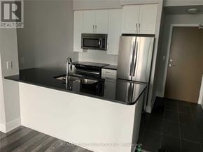 Mississauga (City Centre) condo for rent - A kitchen with a black countertop and stainless steel appliances.