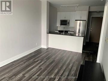 Mississauga (City Centre) condo for rent - A kitchen area with a refrigerator, microwave, and stove top oven.