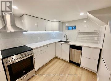 Toronto (Weston) apartment for rent - A modern kitchen with white cabinets and a stainless steel oven.