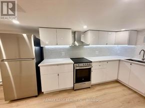 Toronto (Weston) apartment for rent - A modern kitchen with white cabinets and stainless steel appliances.