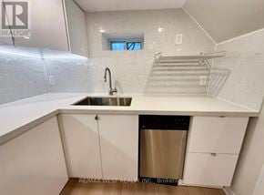 Toronto (Weston) apartment for rent - A modern kitchen with white cabinets and a stainless steel dishwasher.