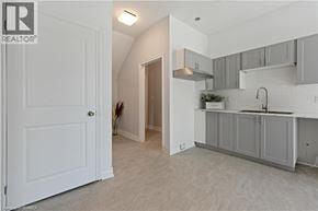Brantford apartment for rent - A white door is open to a kitchen area.