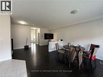 Brantford apartment for rent - A living room with a dining table set up with chairs.