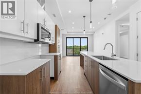 Windsor condo for rent - A modern kitchen with wooden cabinets and stainless steel appliances.