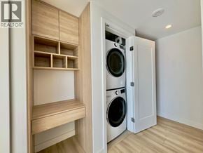 Burnaby apartment for rent - A laundry room with a washer and dryer built into a cabinet.