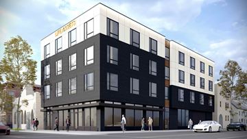 Newark apartment for rent - A modern building with the words "LIFE ASPIRES" on the top floor.