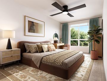 Littleton apartment for rent - A bedroom with a large bed and a ceiling fan.