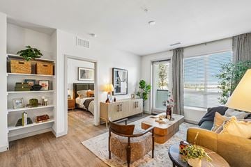 Littleton apartment for rent - A well-lit living room with a yellow couch and a wooden coffee table.