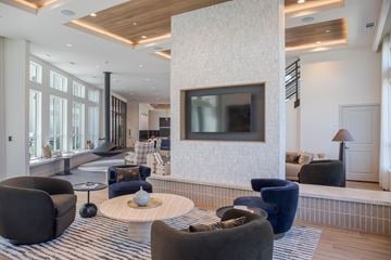 Littleton apartment for rent - A modern living room with a large television and comfortable seating.