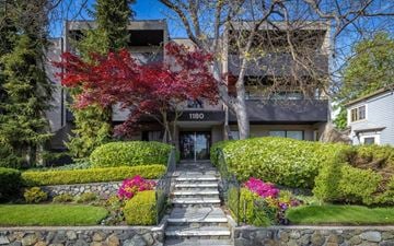 Victoria apartment for rent - A tree with red leaves is in front of a building with the number 1180 on it.