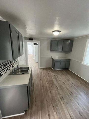 East Chicago apartment for rent - A kitchen with a sink and a refrigerator.