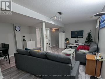 Kingston (Kingston East (Incl Barret Crt)) apartment for rent - A living room with a grey couch and a wooden cabinet.