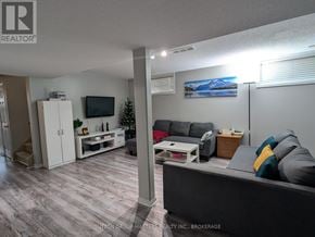 Kingston (Kingston East (Incl Barret Crt)) apartment for rent - A living room with a grey couch and a television on the wall.