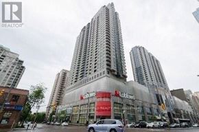 Toronto (Willowdale East) condo for rent - A tall building with a Lowe's Real Estate sign on the front.
