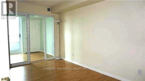 Toronto (Willowdale East) condo for rent - A room with a sliding glass door and wooden flooring.
