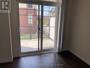 Hamilton (Meadowlands) townhouse for rent - A room with a sliding glass door leading to a balcony.