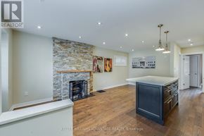 Toronto (Birchcliffe-Cliffside) apartment for rent - A spacious living room with a stone fireplace and a large island.