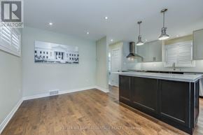 Toronto (Birchcliffe-Cliffside) apartment for rent - A kitchen with a wooden floor and a large island.