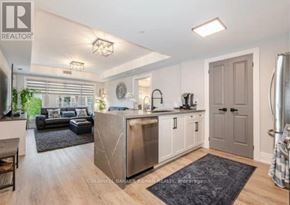 King (Schomberg) condo for rent - A modern kitchen with a large island and a dining area.