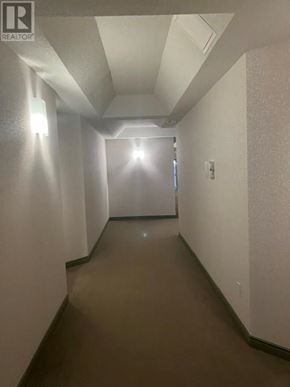 St John's house for rent - A long hallway with a light at the end.