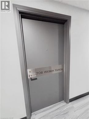 Kitchener condo for rent - A door with a sign that says 706 Weber Yards.