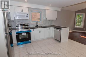 Aurora (Bayview Wellington) apartment for rent - A kitchen with white cabinets and a fridge.