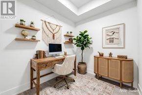 Toronto (Dovercourt-Wallace Emerson-Junction) condo for rent - A home office with a desk, chair, and shelves with plants and decorations.
