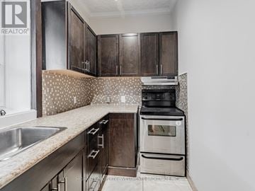 Toronto (Palmerston-Little Italy) apartment for rent - A kitchen with dark wood cabinets and a patterned backsplash.