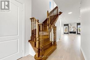 Newmarket (Woodland Hill) apartment for rent - A wooden staircase in a house leads to the second floor.