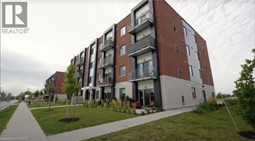 Ayr apartment for rent - A modern apartment building with balconies and a walkway in front.
