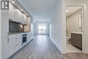 Toronto (Dovercourt-Wallace Emerson-Junction) condo for rent - A spacious kitchen with white cabinets and a large island.
