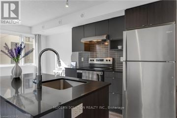 Burlington (Lasalle) townhouse for rent - A modern kitchen with a stainless steel refrigerator and a marble countertop.