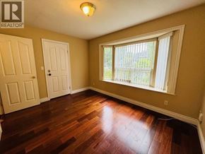 Vancouver apartment for rent - A room with a window and a wooden floor.