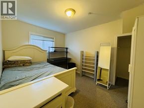 Vancouver apartment for rent - A bedroom with a bed, dresser, and closet.