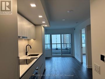 Toronto (North St. James Town) condo for rent - A modern kitchen with a sink and a window.