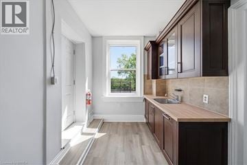 Paris apartment for rent - A kitchen with wooden cabinets and a window.