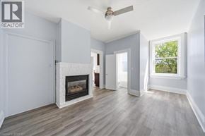 Paris apartment for rent - A living room with a fireplace and a ceiling fan.