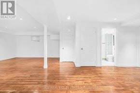 Toronto (Broadview North) apartment for rent - A room with wooden floors and white walls, with a door on the right side.
