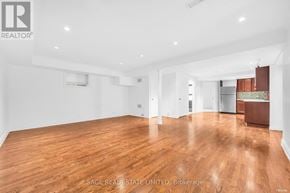 Toronto (Broadview North) apartment for rent - A spacious room with wooden flooring and white walls.