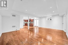 Toronto (Broadview North) apartment for rent - A spacious room with wooden flooring and white walls.