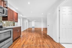 Toronto (Broadview North) apartment for rent - A kitchen with wooden floors and white walls.