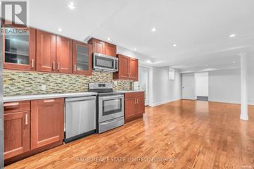 Toronto (Broadview North) apartment for rent - A kitchen with wooden cabinets and a stone backsplash.